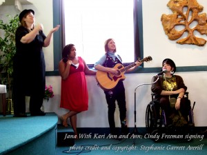 Jana with Kari Ann and Ann singing and Cindy interpreting (photo)